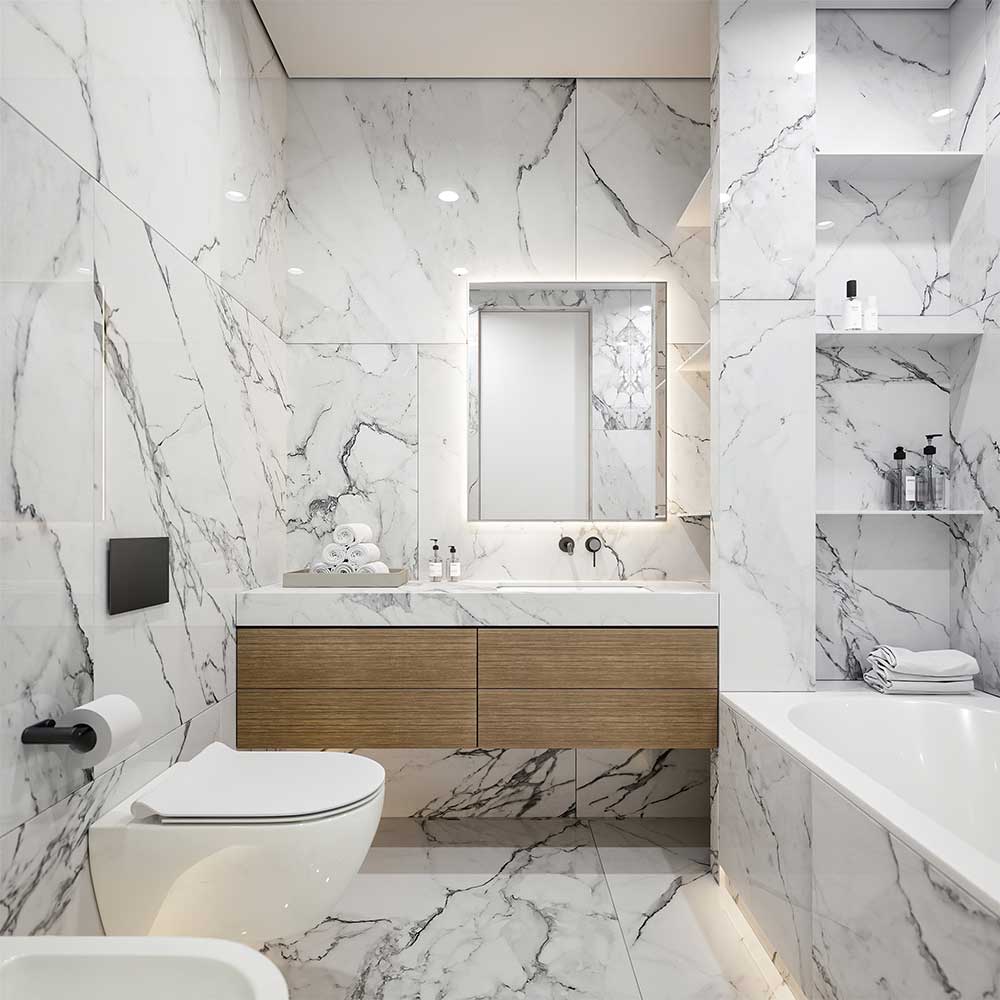 Modern looking bathroom with marble tiles & faience, a tub, a freestanding toilet & sink